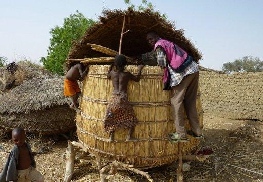 Children from the Tarna village climb on a grain silo in southern Niger in 2010